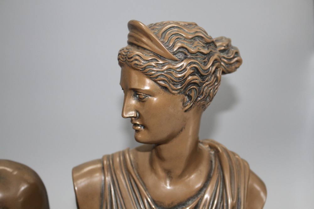 A pair of bronzed resin busts of Diana and Apollo, on integral bases, height 30cm